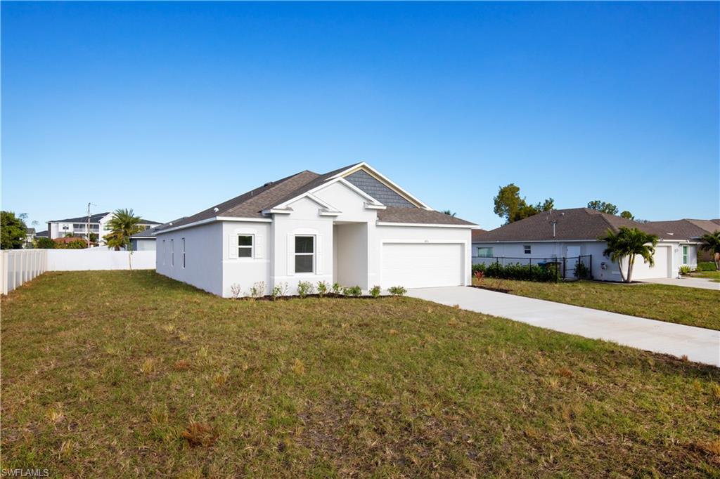 Single story home featuring concrete driveway, stucco siding, and an attached garage
