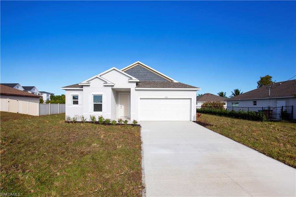 View of front of home with concrete driveway, a garage, and stucco siding