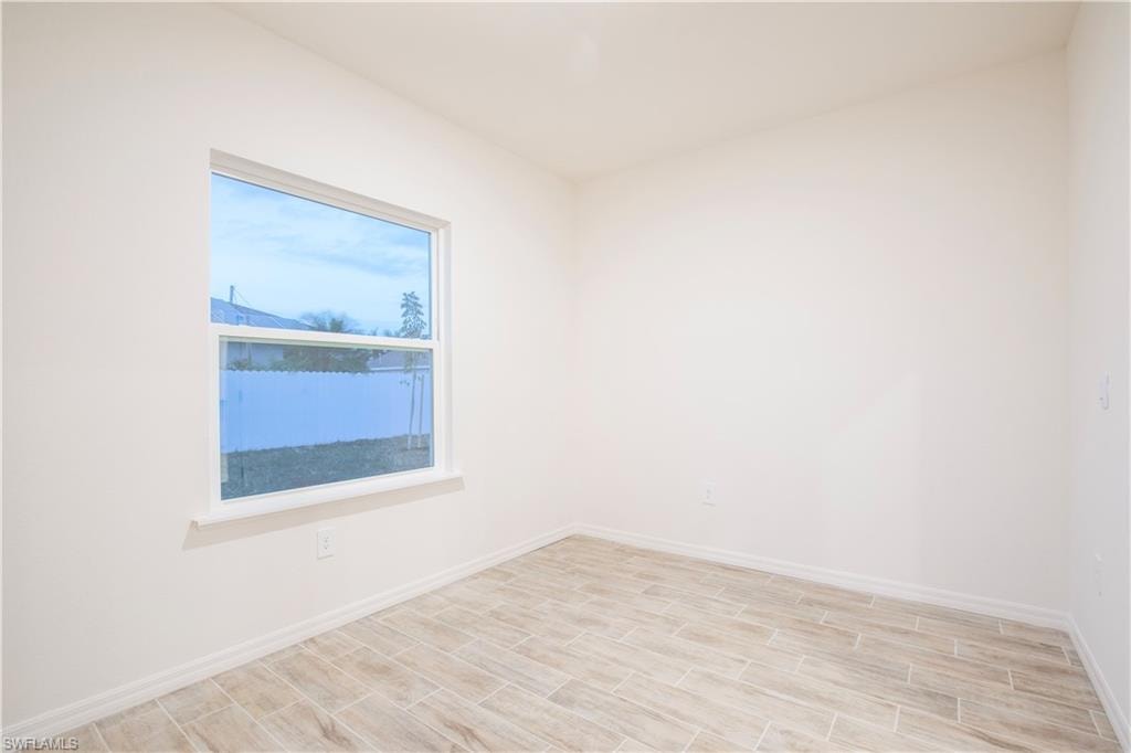 Spare room with wood finish floors and baseboards