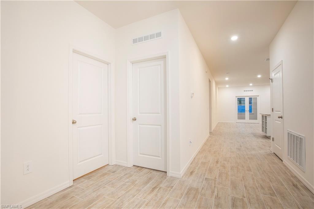 Hall featuring wood tiled floors and recessed lighting