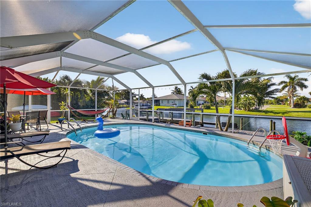View of patio with outdoor dining area, an outdoor hangout area, an outdoor pool, a water view, and a ceiling fan
