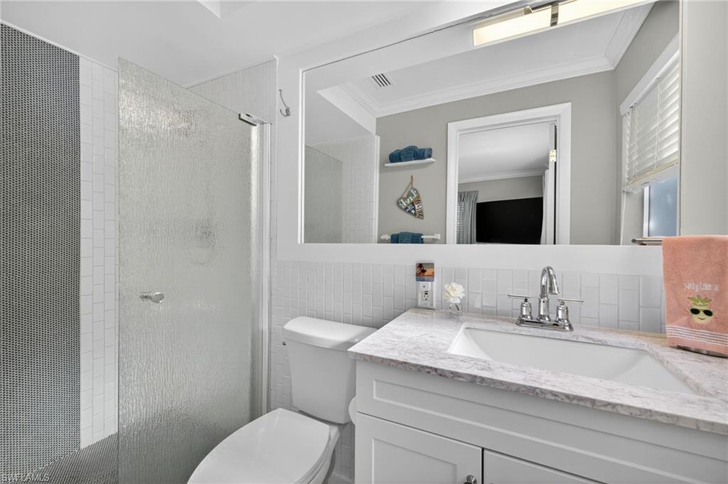 Bedroom with access to exterior, crown molding, and light tile patterned floors