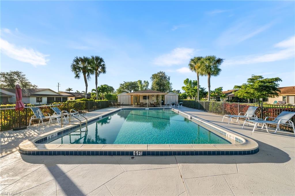 Community pool featuring a patio area and an outdoor structure