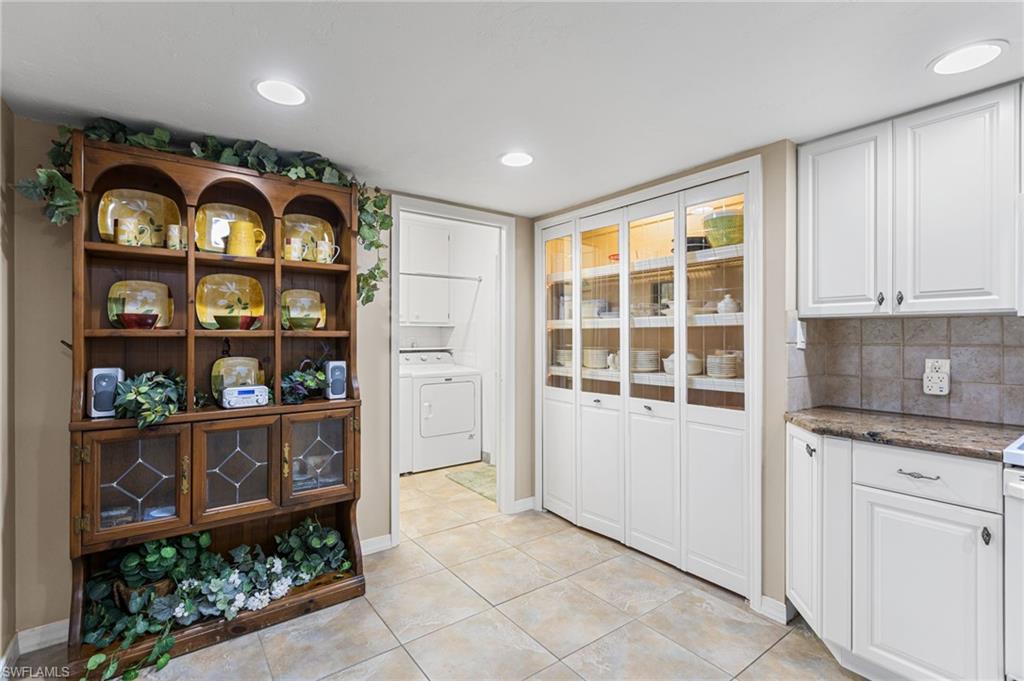 Lighted pantry, doorway to laundry room and garage
