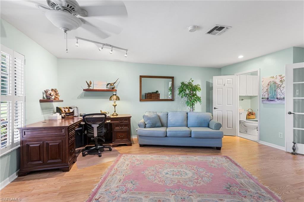 Home office featuring light wood-style floors, ceiling fan, and rail lighting