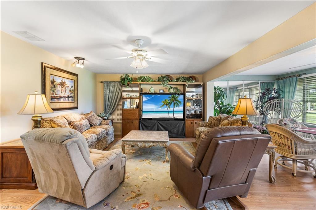 Living room featuring wood finished floors and a ceiling fan