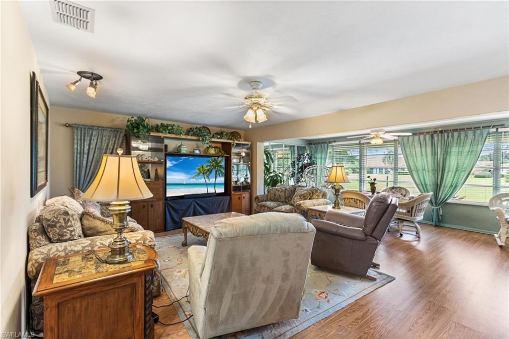 Living area with wood finished floors and ceiling fan