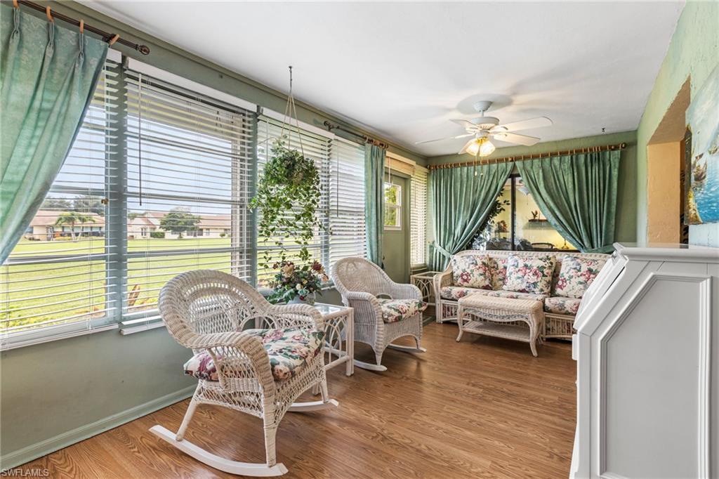 Sunroom with wood finished floors and baseboards