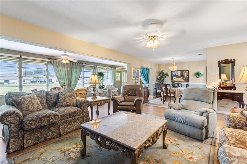 Living area with a ceiling fan and wood finished floors