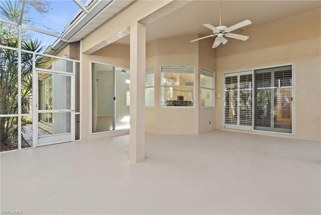 View of patio / terrace with a ceiling fan, a sunroom, and glass enclosure