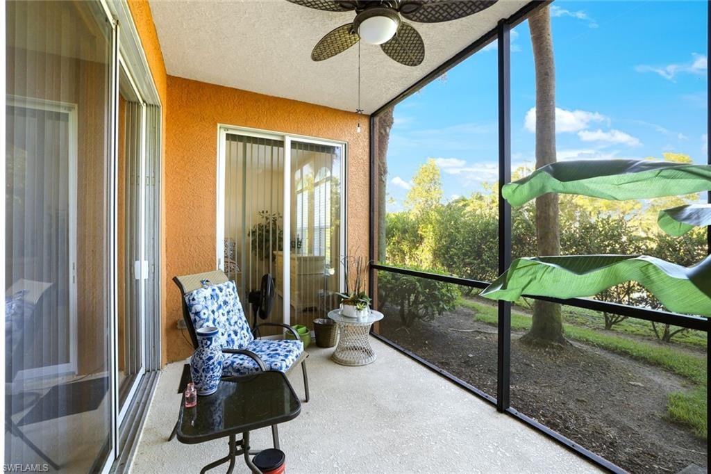 Sunroom with a textured wall and a textured ceiling
