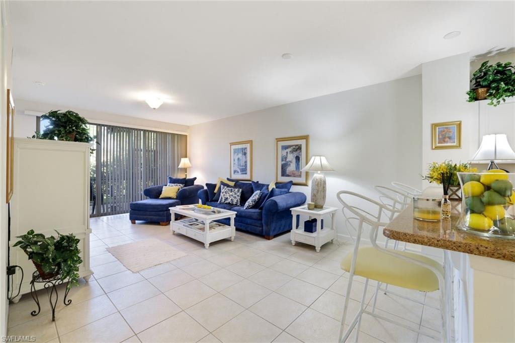 Living area featuring light tile patterned floors and baseboards