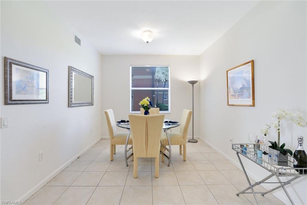 Dining space featuring light tile patterned flooring and baseboards