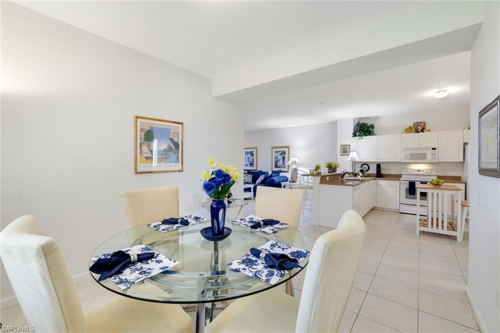 Dining area featuring light tile patterned floors