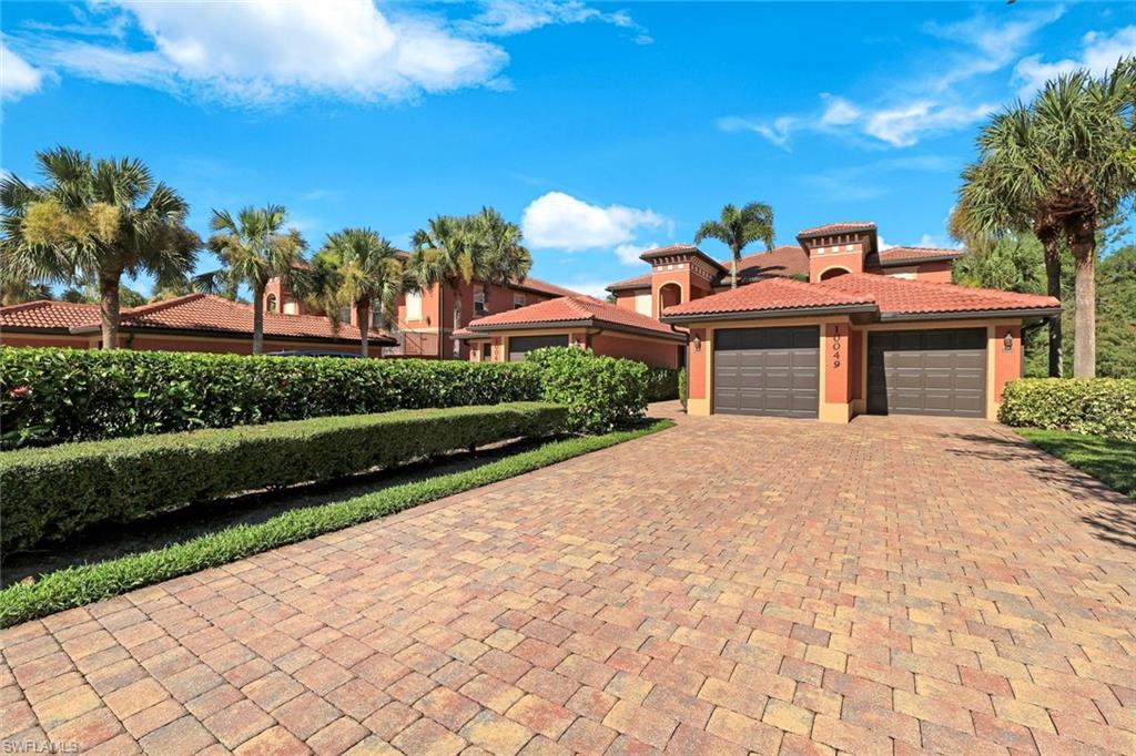 View of front of home featuring decorative driveway, stucco siding, a tiled roof, and an attached garage