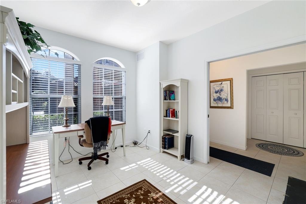 Home office featuring light tile patterned flooring and baseboards