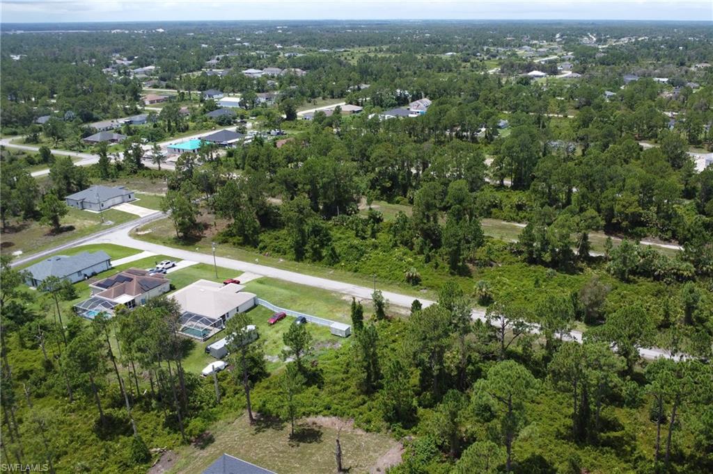 Aerial view of property's location with a forest