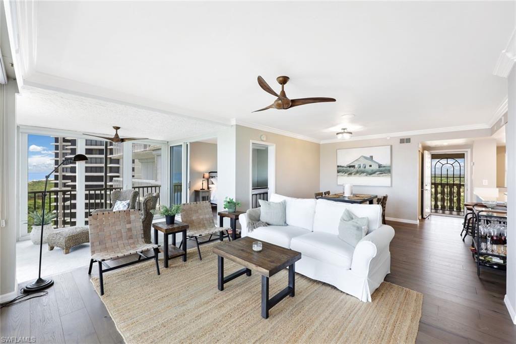 Living room with ornamental molding, ceiling fan, and hardwood / wood-style floors
