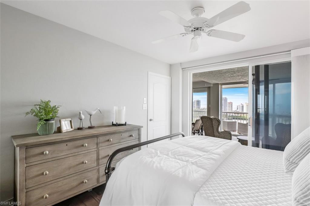 Bedroom with access to outside, dark hardwood / wood-style floors, and ceiling fan