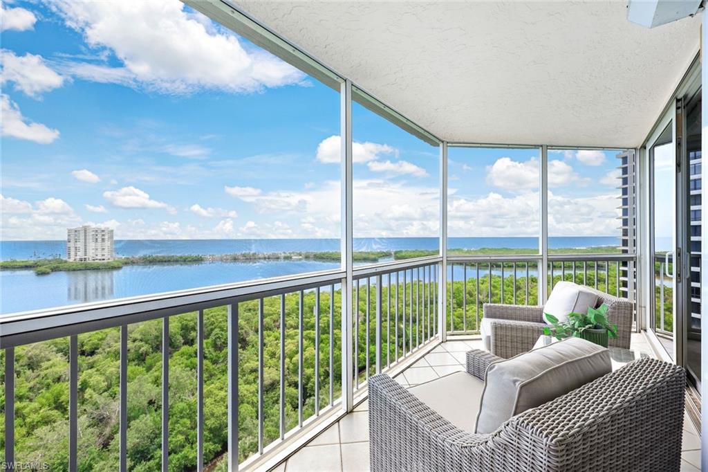 Sunroom / solarium featuring a water view