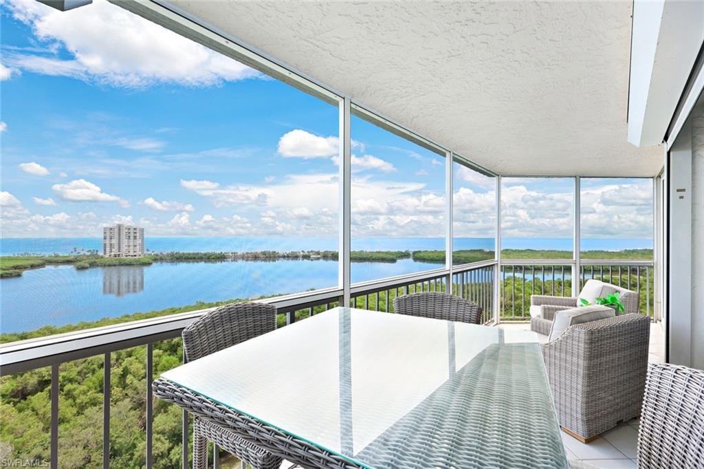 Sunroom featuring a water view