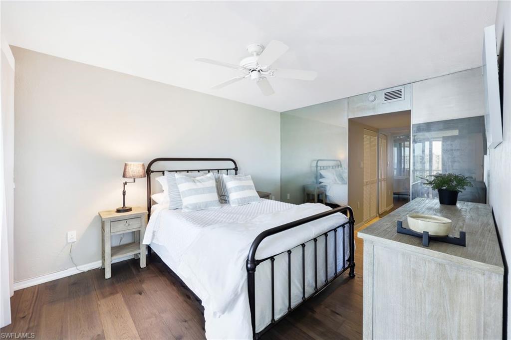Bedroom with dark wood-type flooring and ceiling fan