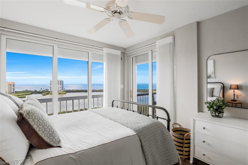 Bedroom featuring a water view, access to exterior, and ceiling fan