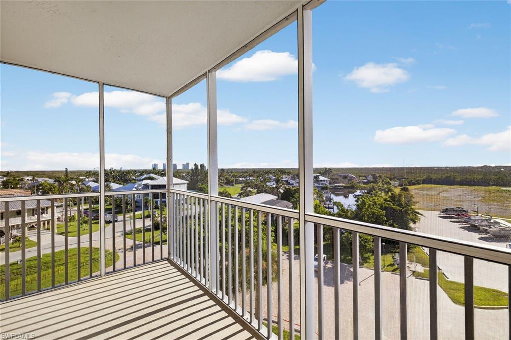 Balcony with a sunroom and a water view