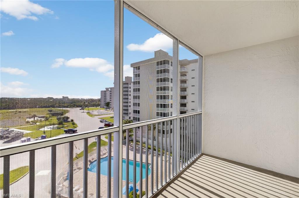 Balcony with view of pool area and a sunroom