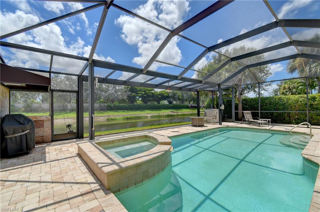 Note the spacious pool/spa screened cage area with a  picture window