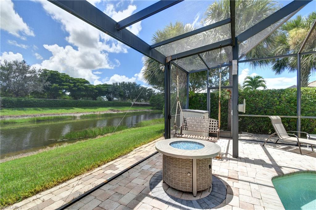 Pool lanai is oversized with room for this fire pit and swing; storage area in the corner for pool equipment, etc