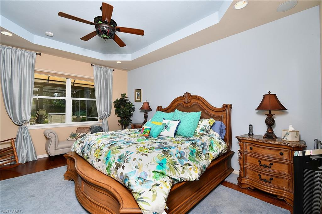 Master BR with tray ceiling; Wood-like flooring