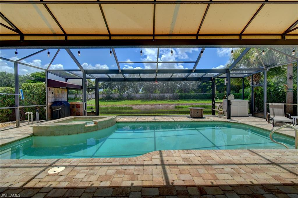 Pool/water view from the LR and covered lanai area and a permanent awning across the back of the house