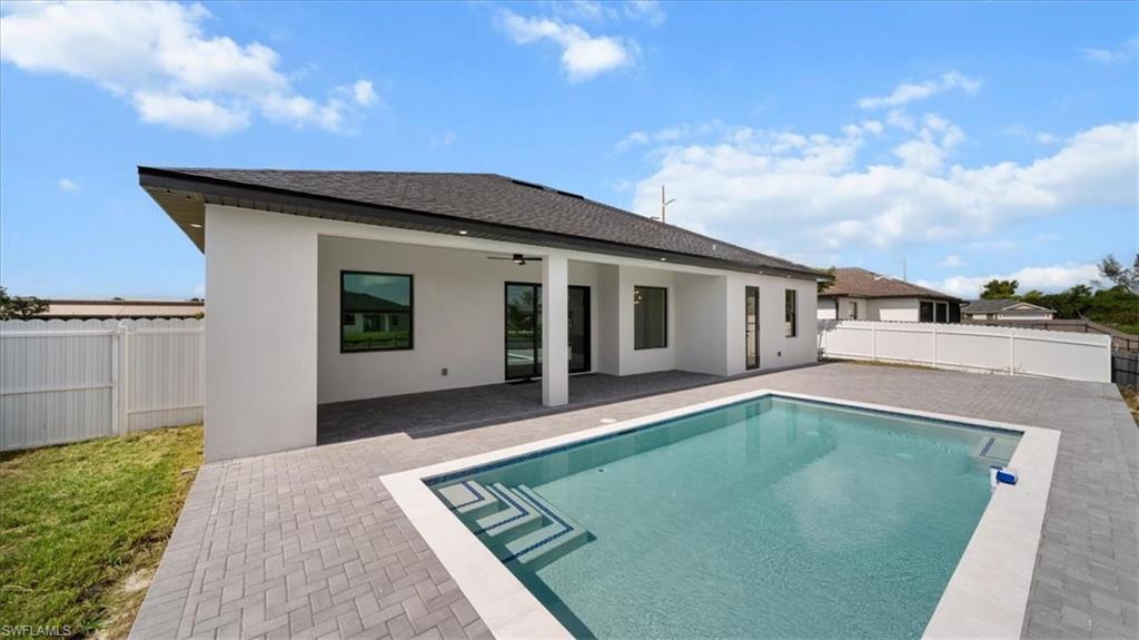 View of swimming pool with a patio area and a fenced backyard