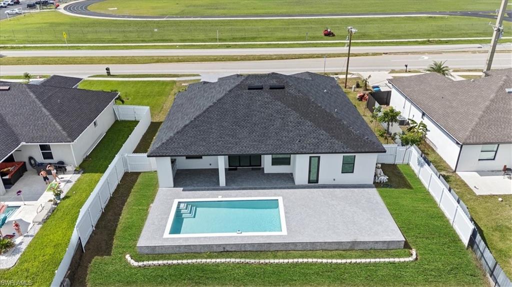 Aerial view of property and surrounding area featuring a pool area