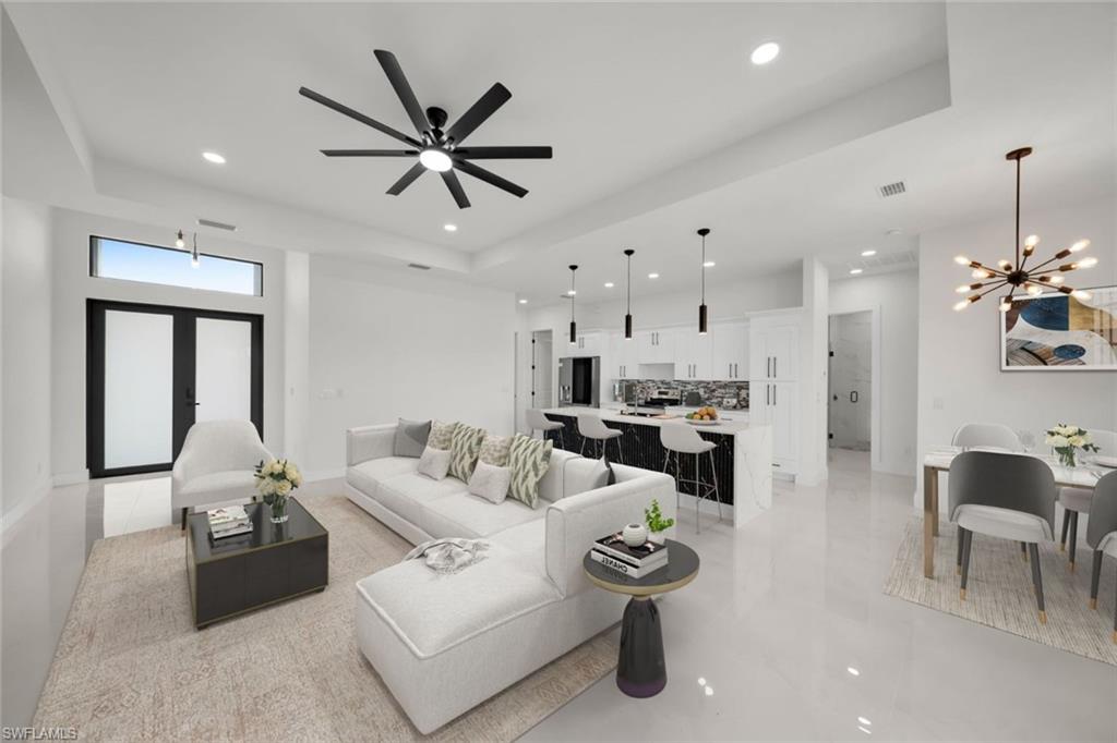 Kitchen featuring appliances with stainless steel finishes, backsplash, a chandelier, white cabinetry, and recessed lighting