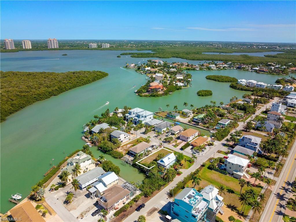 Aerial overview of property's location with nearby suburban area and a large body of water