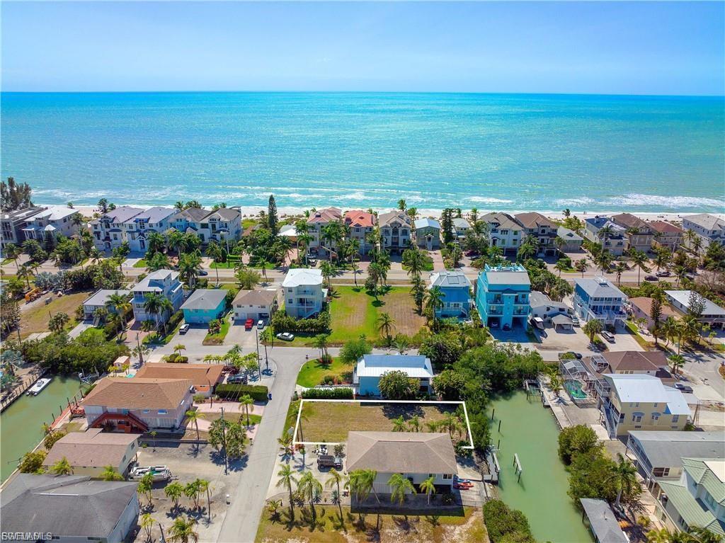 Aerial perspective of suburban area with a nearby body of water