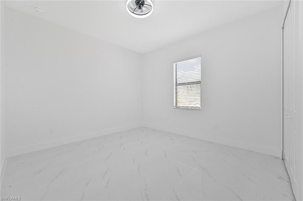 Empty room with light marble finish floors and baseboards