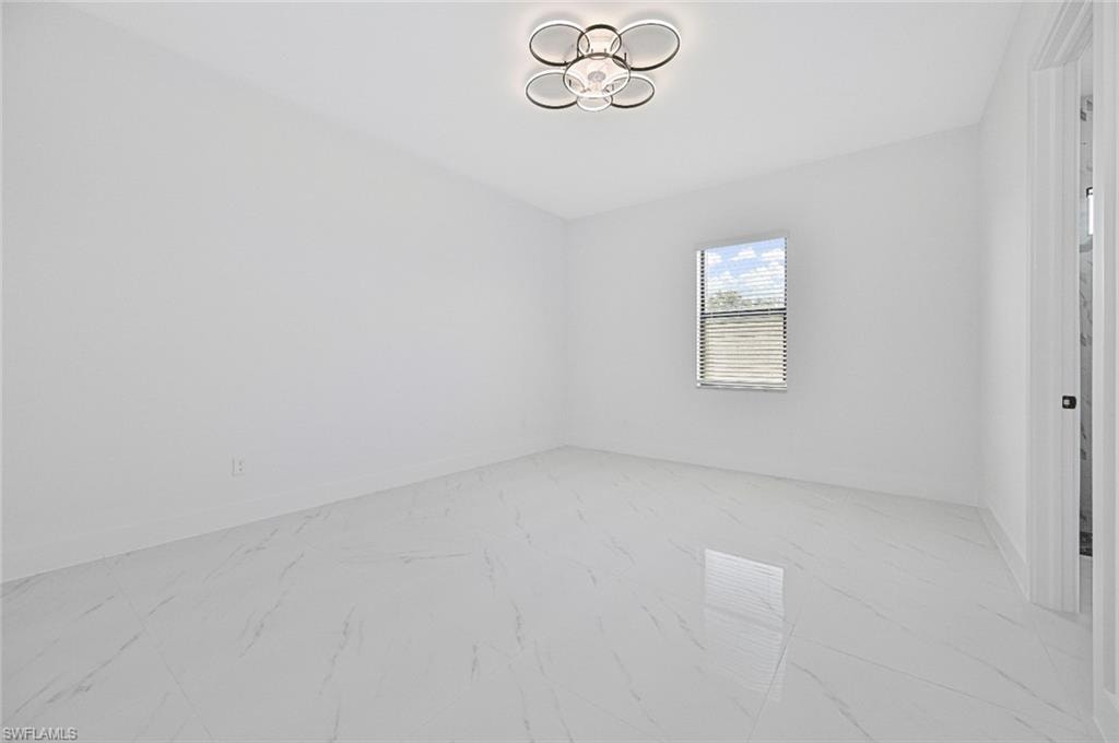 Empty room with light marble finish flooring and baseboards