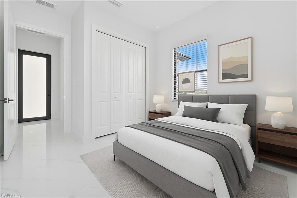 Bedroom with a closet and light marble finish flooring