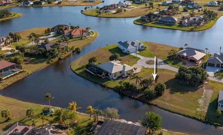 Aerial view of residential area featuring a nearby body of water