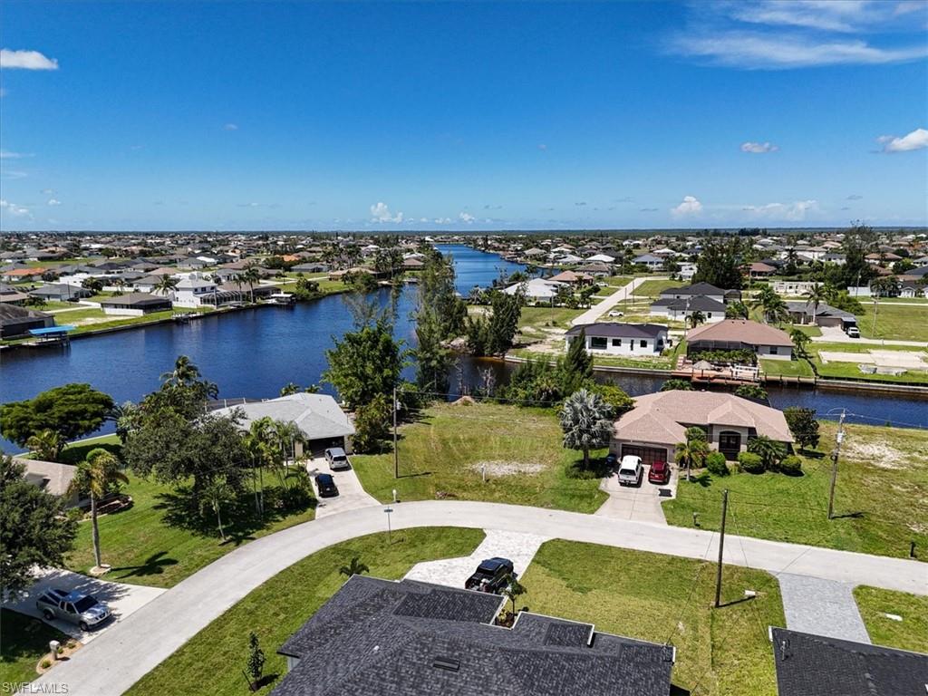Aerial view of residential area featuring a large body of water