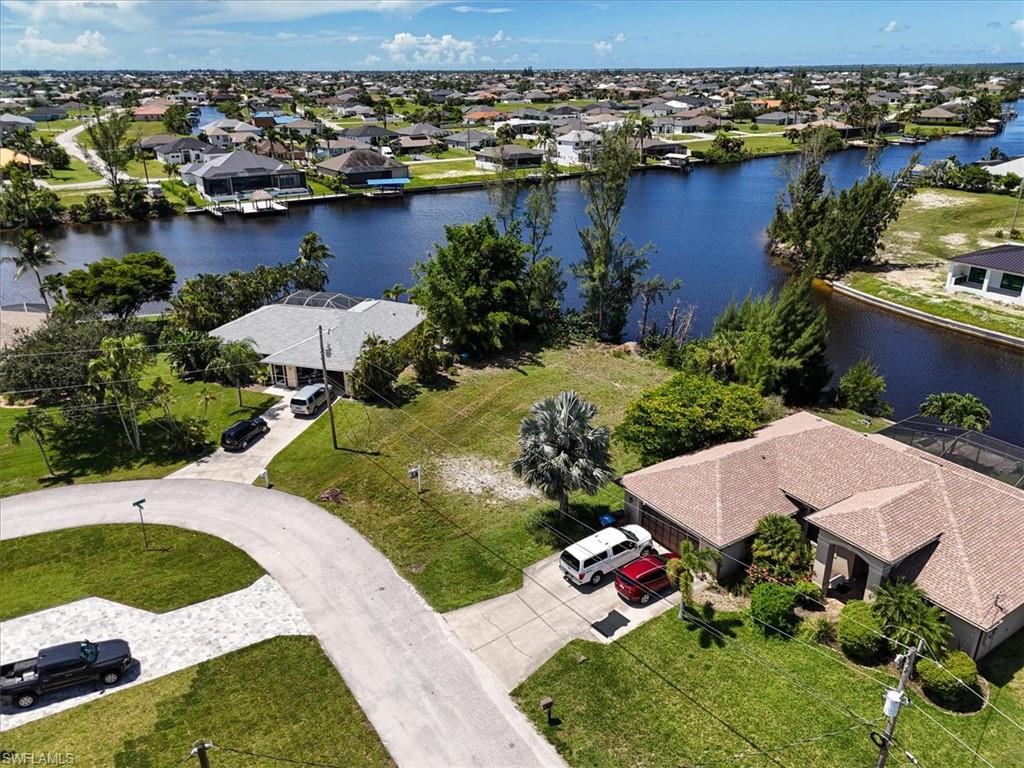 Aerial perspective of suburban area featuring a nearby body of water