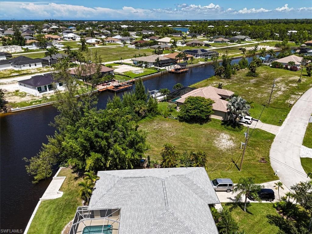 Aerial view of residential area featuring a nearby body of water