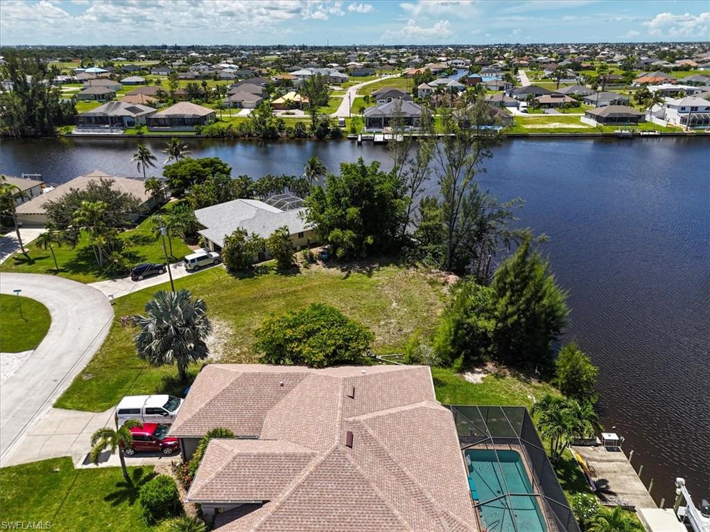 Aerial view of residential area featuring a large body of water