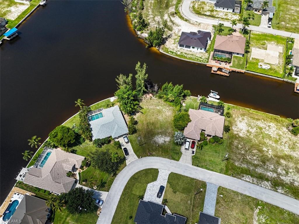 Aerial view of property's location featuring nearby suburban area and a large body of water
