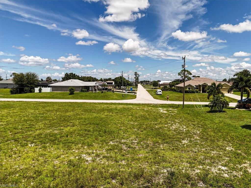 View of property's community featuring a yard