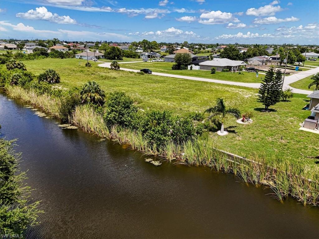 Aerial perspective of suburban area with a nearby body of water