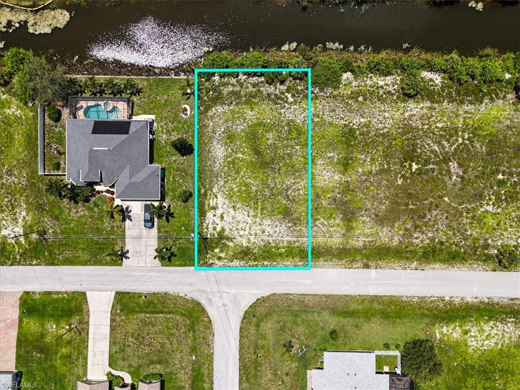 Aerial view of property's location featuring property parcel outlined and a nearby body of water